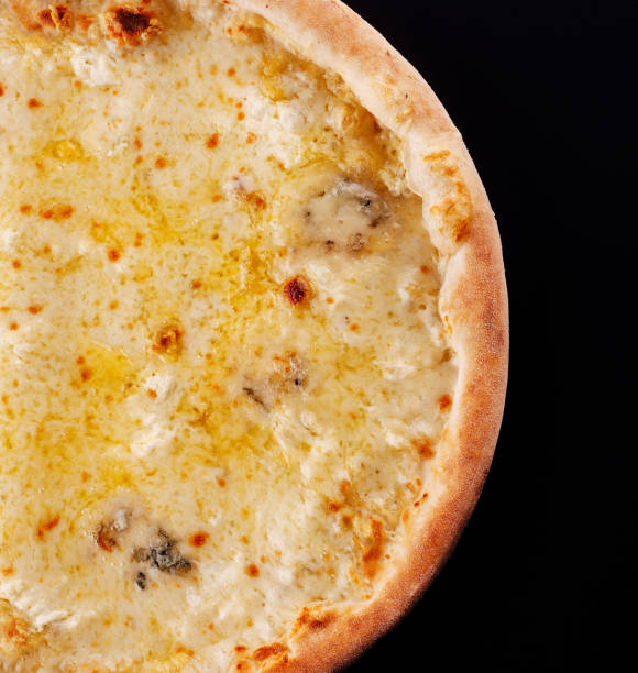 istock Pizza four cheeses on a black background 1486522900