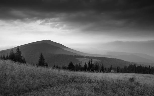Amazing landscape of mountain hills at sunrise. Black and white effect. stock photo