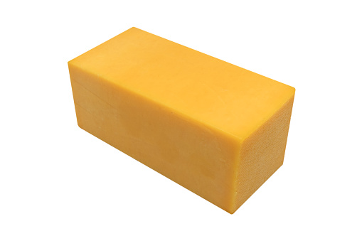 Cheese block isolated on white background with clipping path. Closeup view of a piece of cheese. Piece of delicious fresh cheddar cheese.