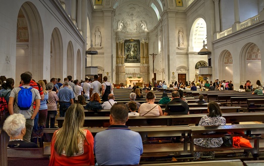 Fatima, Portugal - August 15, 2022: Interior of Sanctuary of Our Lady of the Rosary of Fatima Basilica with congregation some motion blurred