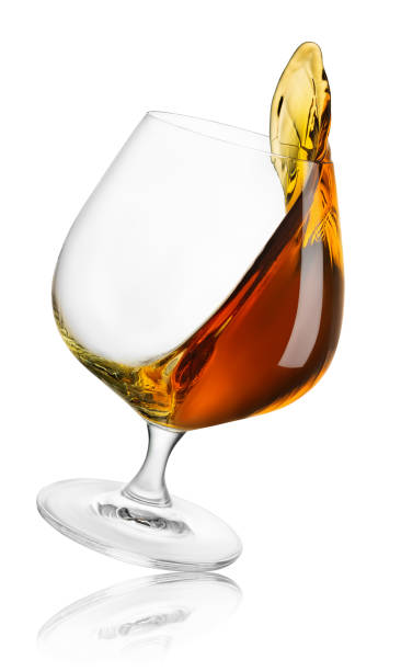 istock falling glass of brandy with splash isolated on white 1486524244