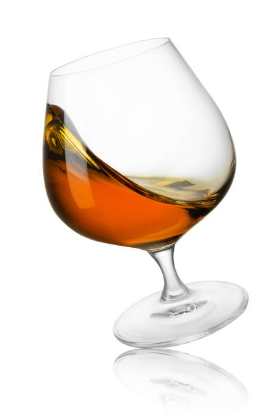 istock falling glass of cognac with splash isolated on white 1486524246