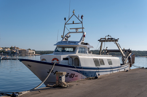 Portocolom, Spain; april 23 2023: Industrial fishing boat moored at the dock of the Majorcan town of Portocolom, Spain