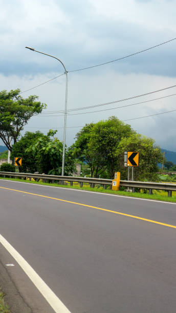 istock Road markings at sharp turns. Traffic signs. 1486525962
