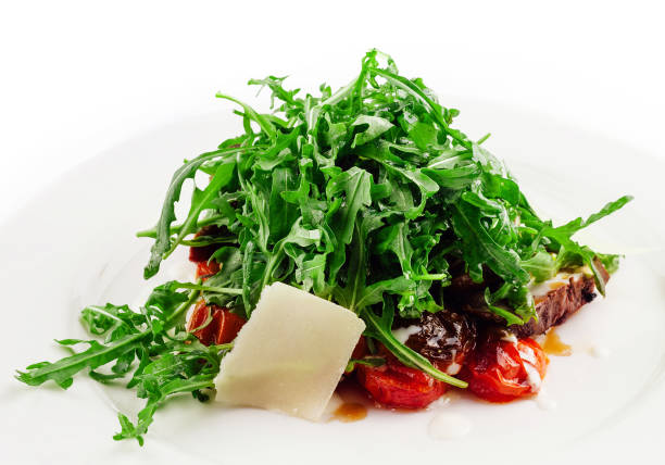 Italian beef tagliata salad with wild rocket, cherry tomatoes and parmesan cheese