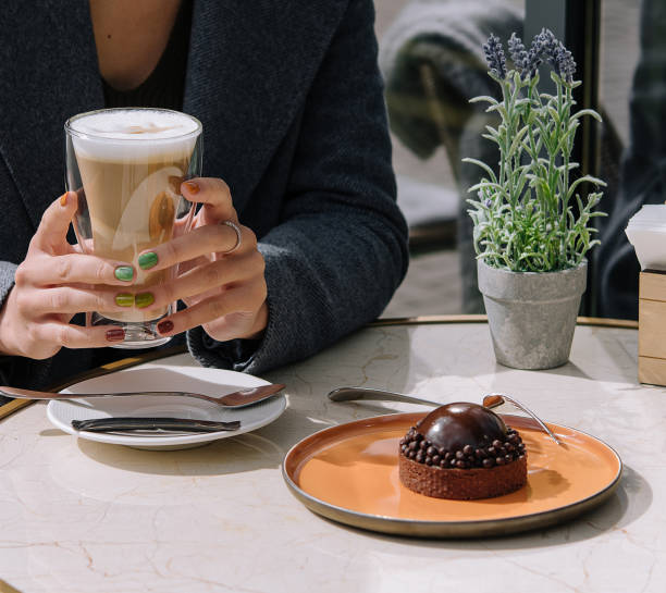 istock female in cafe eating cake and drinking latte 1486527152