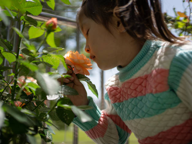 istock children smelling flowers 1486530316