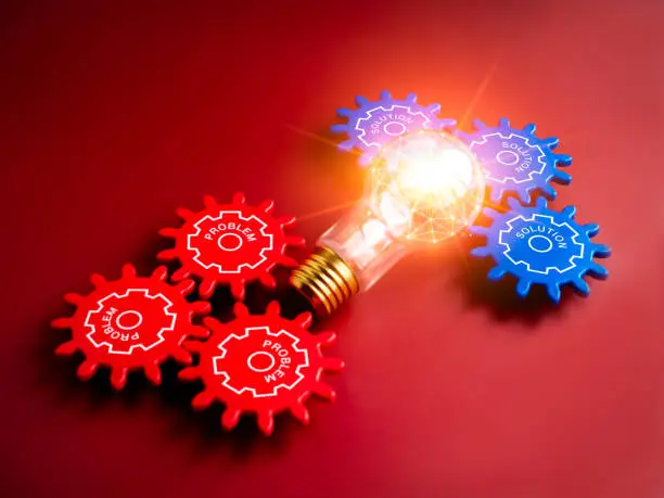 Photo of Shiny light bulb with polygon link inside connected between blue with solution, words and red, problem, text on gear wheels on blue background. Business strategy, management with technology concepts.