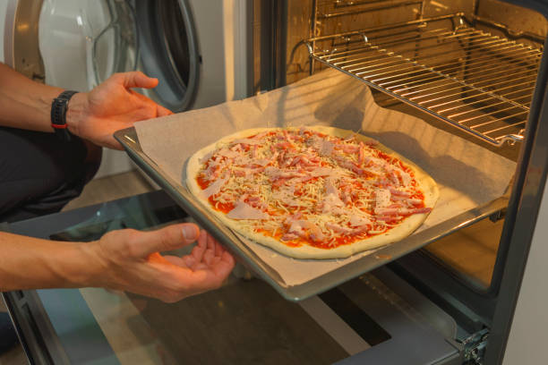 istock Delicious Homemade Pizza Baking in the Oven 1486535095