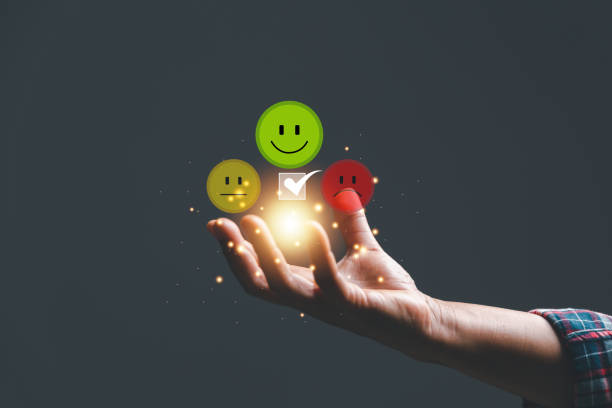 istock Customer experience with customer service and satisfaction concept. Woman hand holding face smile face icon on wooden cube with copy space 1486536777