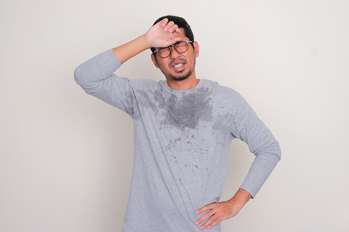 Adult Asian man sweating during hot summer day