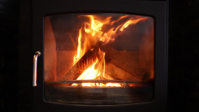 Logs on fire burning in a wood burner