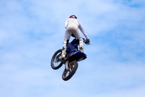 Pleyber-Christ, France - August, 28 2022: Biker doing a freestyle trick with his dirt bike.