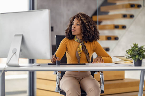 istock Female entrepreneur with computer working in modern office 1486539726