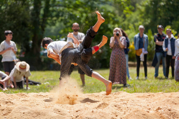 Pleyber-Christ, France - May 29 2022: Two young men practicing Breton wrestling (gouren) taking place on sawdust.