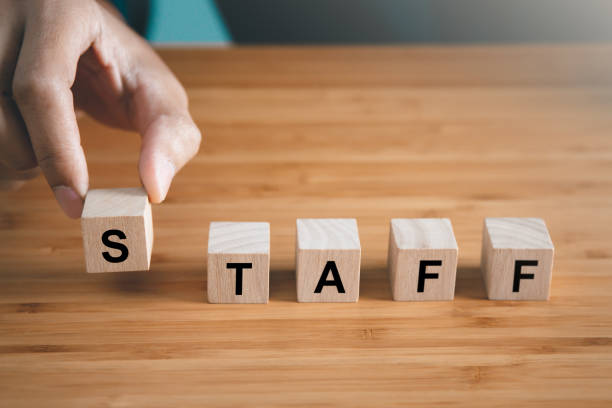 istock Businessman hold wooden block with  Staff text. teamwork and organization concept 1486540001