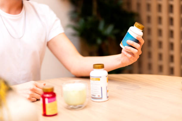 istock Man is holding vitamin pill box 1486542641