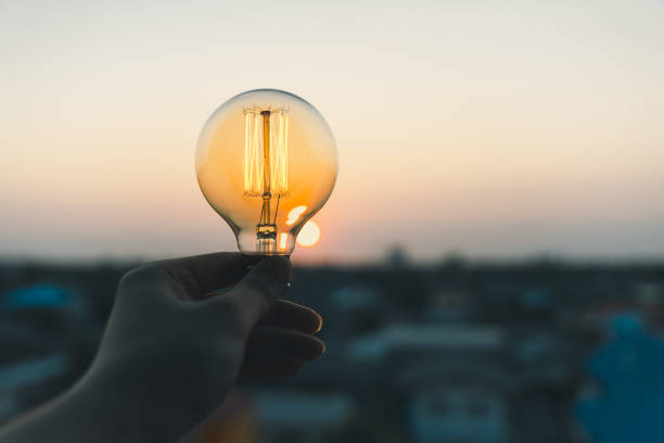 istock Hand business man holding light bulb. Alternative energy, idea, saving electricity innovation and inspiration concepts. 1486543987