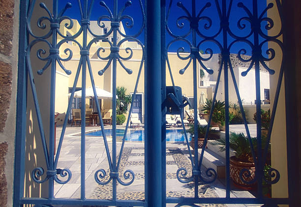 Elegant hotel in Santorini ,Greece Peaceful afternoon hotel's garden in santorini,Greece pool gate stock pictures, royalty-free photos & images