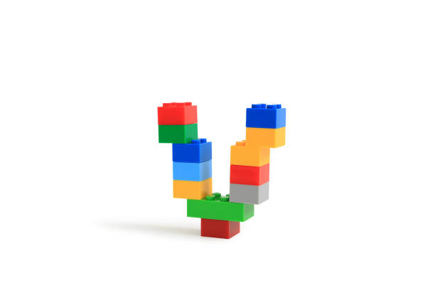 istock Alphabet letters V from colorful plastic brick block constructor isolated on white background. Image with Clipping path 1486554217