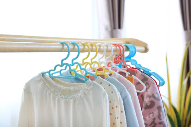 istock Hangers with clothes hang on a wood rack in house 1486555437