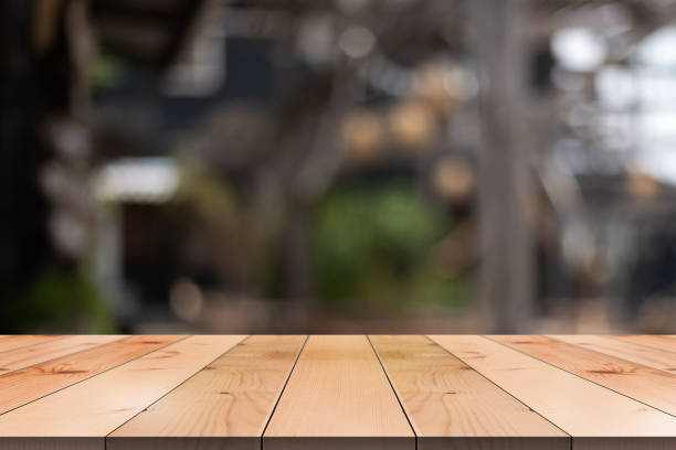 istock Empty wooden table top with lights bokeh on blur restaurant background. 1486557392