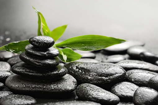 Black basalt stones and bamboo with drops