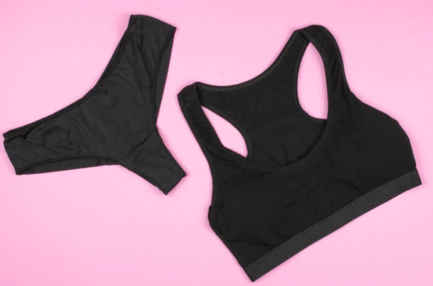 istock Black women's panties and undershirt on a pink background 1486558377