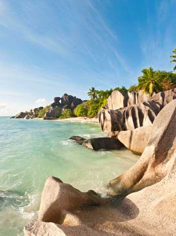 The iconic sculpted granite rocks, warm white sands, swaying palms and clear turquoise waters of the idyllic tropical beach and island lagoon at Anse Source d'Argent, La Digue, Seychelles. ProPhoto RGB profile for maximum color fidelity and gamut.