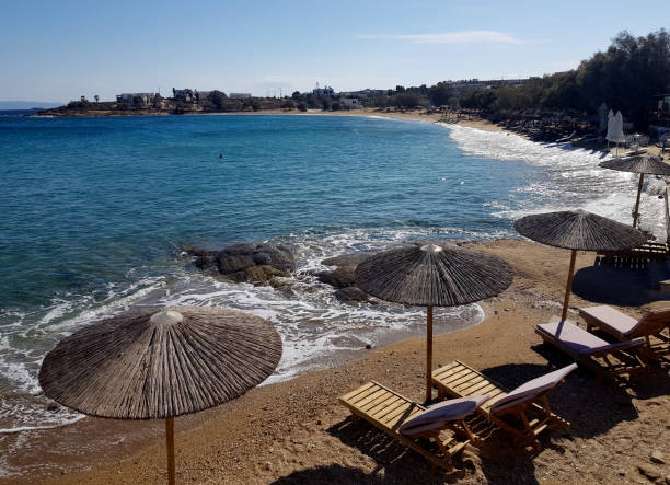 Sun beds and umbrellas on the beach Logaras beach in Paros paros stock pictures, royalty-free photos & images