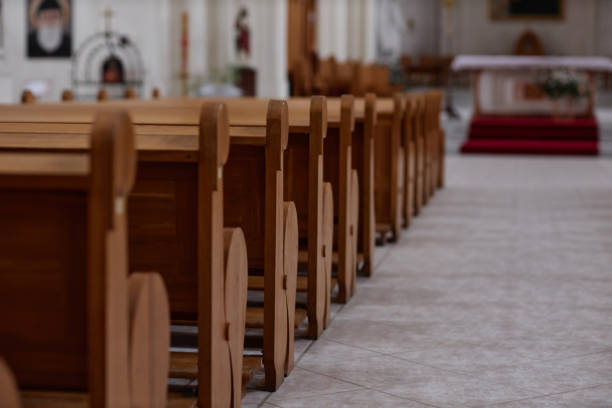 istock Old wooden benches in church 1486567362