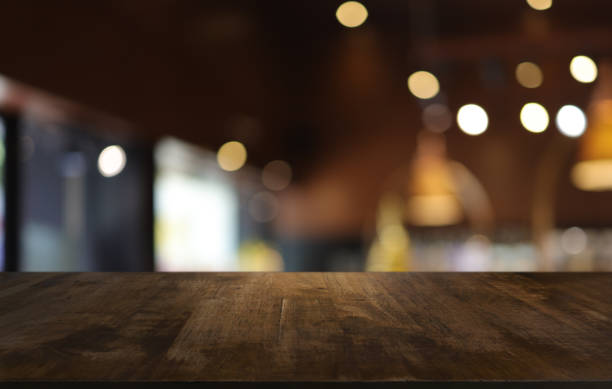 istock Wood table top in front of abstract blurred background. Empty wooden table space for text marketing promotion. blank wood table surface copy space 1486567404