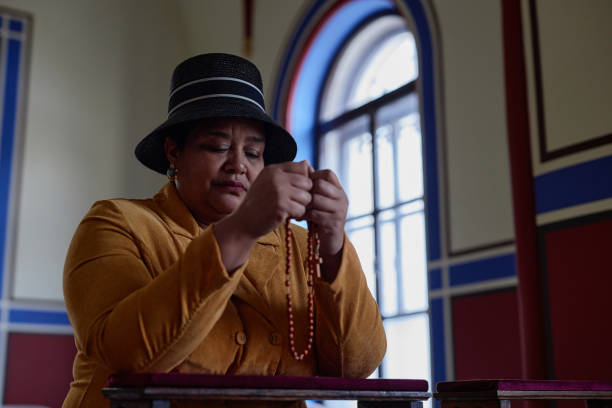 istock Elegant woman using rosary beads in her prayer 1486567414