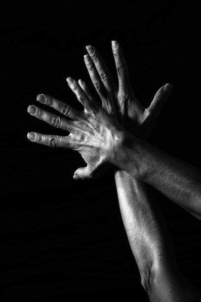 istock Two crossed hands with fingers spread 1486577118