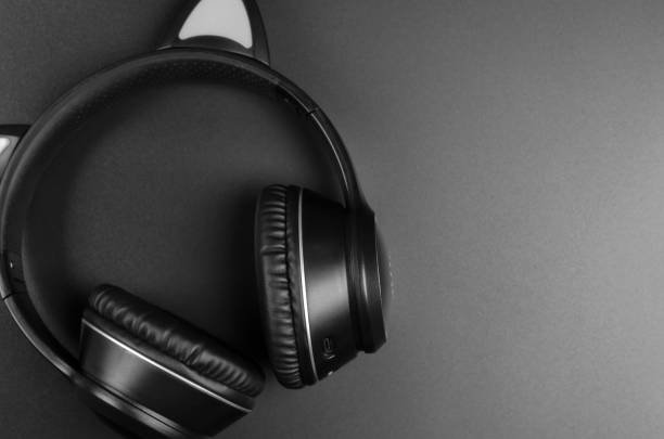 istock Black wireless headphones on a black background, copy space 1486577284