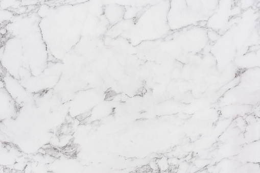 Fine marble texture. Polished surface of a white marble with black patterns.