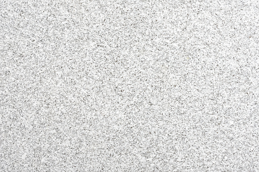 Polished surface of the granite slab. Due to its durability, granite is often used in the construction industry, both for exteriors and for interiors (flooring tiles, facades, as a pavement material, bathrooms, kitchen counters...).