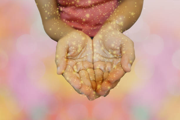 istock Hands with hopes with spakle lights effects. Hope concept 1486581300
