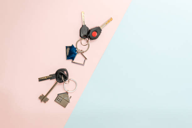 istock Keys with keychain with shape of house on two colored background 1486582268