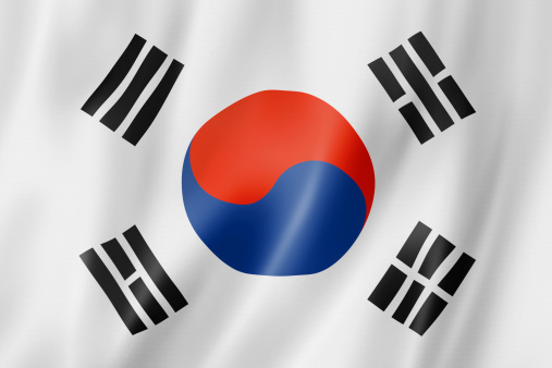 Small paper flag of South Korea pinned. Isolated on white background. Horizontal orientation. Close up photography. Copy space.