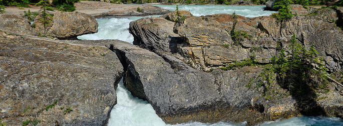 Panoramic image of the Natural Bridge as the Kicking Horse river flows beneath it