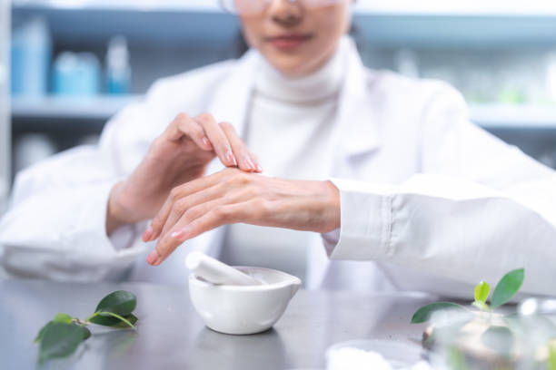 istock Beauty eco cosmetic research and development concept, Scientist or Pharmacist applying moisturizer lotion on her hand for efficacy testing of natural organic skincare products in laboratory 1486586736