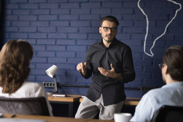 istock Serious confident smart business group leader instructing team 1486590963