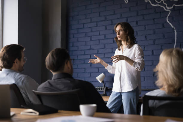Engaged confident business project female leader talking to team