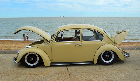 Felixstowe, Suffolk, England - August 29, 2015:  Classic  Beige  VW Beetle Motor Car Parked on Seafront Promenade.