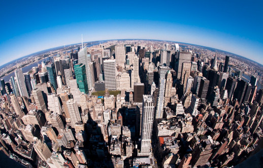 This photo was taken at the top of the Empire State Building (you can see the shadow of the building in the photo) using a fisheye lens. Building logos have been removed