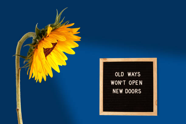 istock Old ways will not open new doors. Motivational quote on a black letter board, on a blue background. Inspirational quote of the day concept. Greeting card, postcard 1486600553