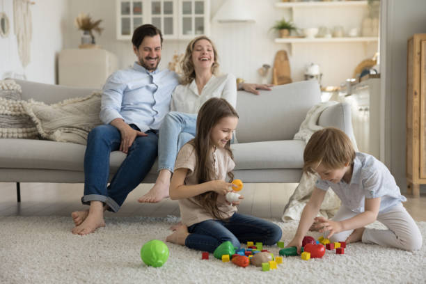 istock Two cheerful excited sibling kids playing with toy blocks 1486601449