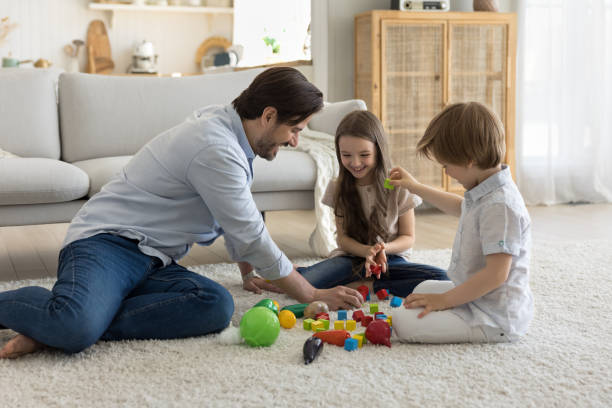 istock Happy daddy engaged in game with son and daughter kids 1486601454