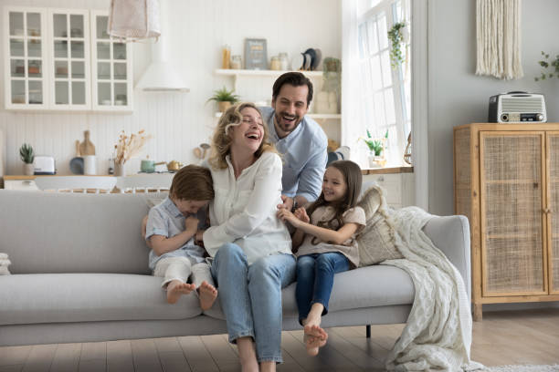istock Joyful young parents playing with little son and daughter 1486602408